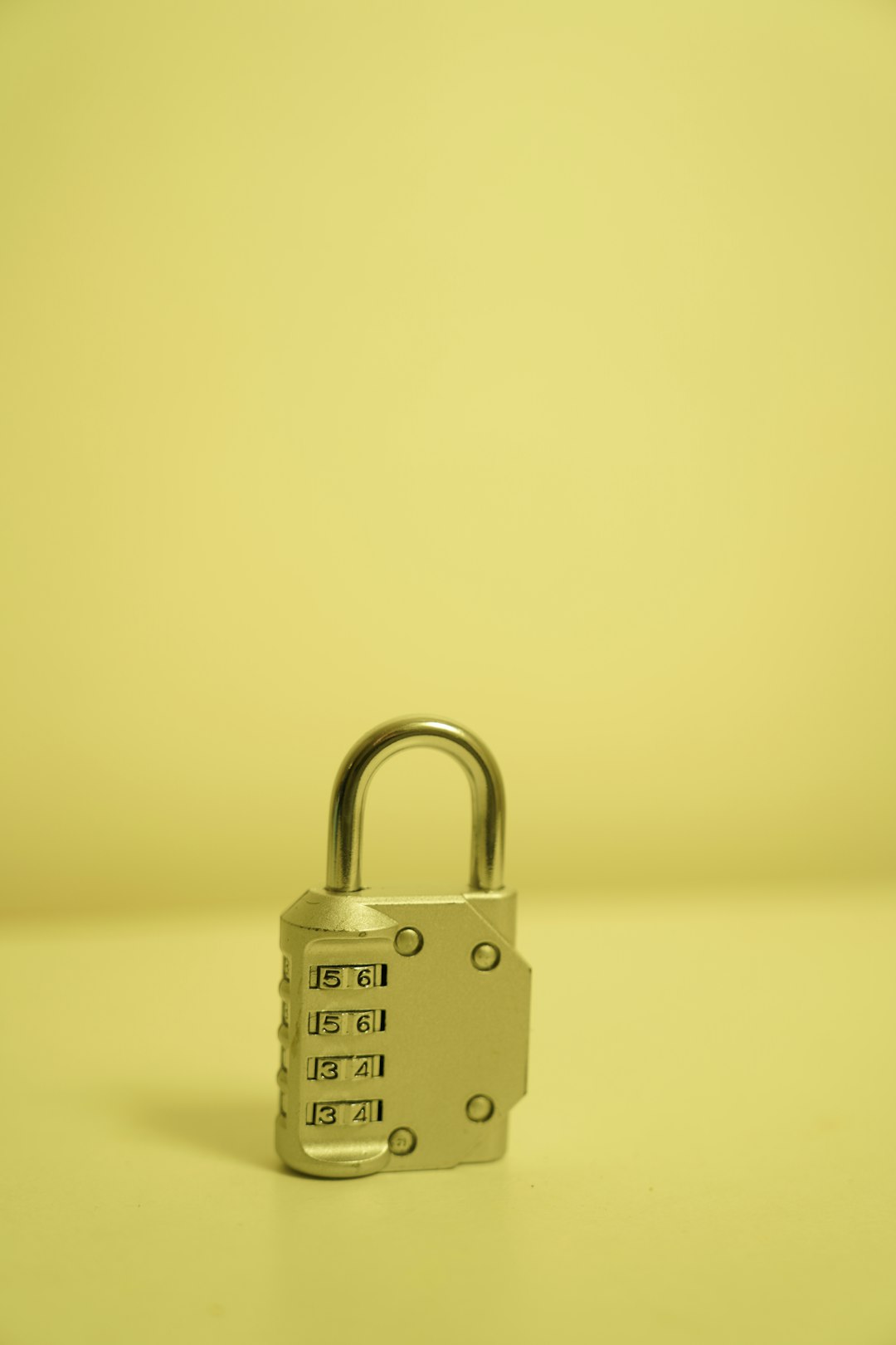 a-padlock-on-a-table-with-a-yellow-background-v3-ioiknjsi
